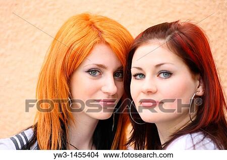 redhead women outdoors in the street against wall View Large Photo Image Picture - redhead women outdoors in the street against wall. Fotosearch
