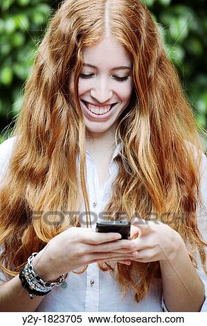 redheaded girl with mobile phone. View Large Photo Image Stock Photography - redheaded girl with mobile phone.. Fotosearch