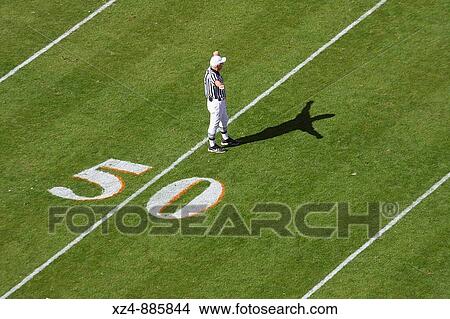referee makes a call at the 50 yard line of a football game View Large Photo Image Picture - referee makes a call at the 50 yard line of a football game. Fotosearch