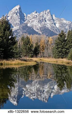 Reflected light on water from the Grand Teton Mountain Range, outside of Jackson Hole, Wyoming This image was shot from the Schabawacker Landing on the snake river View Large Photo Image Stock Photograph - Reflected light on water from the Grand Teton Mountain Range, outside of Jackson Hole, Wyoming This image was shot from the Schabawacker Landing on the snake river. Fotosearch