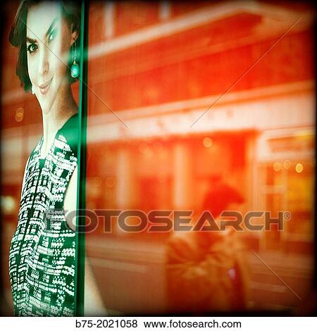 reflection of a man talking on the phone in a glass of a shop in The City of London, England View Large Photo Image Stock Photo - reflection of a man talking on the phone in a glass of a shop in The City of London, England. Fotosearch