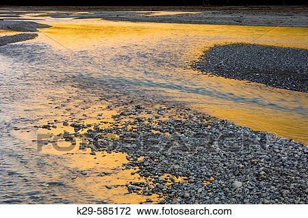 Stock Image - Reflections and gravel beds in Kicking Horse River, Yoho National Park. British Columbia, Canada. Fotosearch