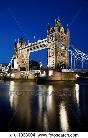 Reflections of the Floodlit Tower Bridge in the River Thames at Dusk London England View Large Photo Image Picture - Reflections of the Floodlit Tower Bridge in the River Thames at Dusk London England. Fotosearch