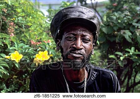 Stock Photography - Reggae native man with hat in colorful gardens near St John Antigua. Fotosearch