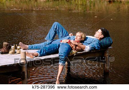 Stock Photograph - relaxing on a dock. Fotosearch
