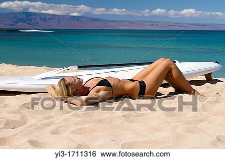 Relaxing on the beach after a stand up padlle session at Napili Bay, Maui, Hawaii View Large Photo Image Stock Photograph - Relaxing on the beach after a stand up padlle session at Napili Bay, Maui, Hawaii. Fotosearch