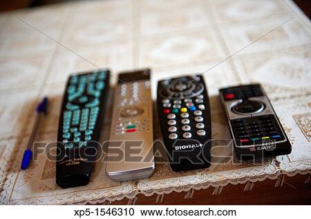 Remote controls on coffee table View Large Photo Image Stock Image - Remote controls on coffee table. Fotosearch