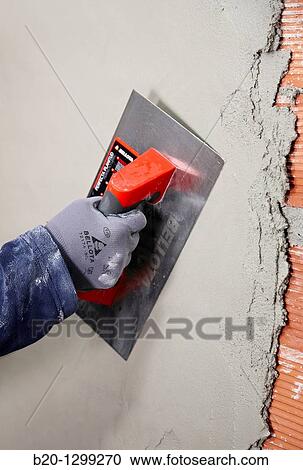 Rendering a brick wall using trowel, new homes under construction, construction site View Large Photo Image Stock Image - Rendering a brick wall using trowel, new homes under construction, construction site. Fotosearch