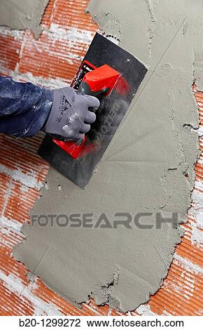 Rendering a brick wall using trowel, new homes under construction, construction site View Large Photo Image Stock Image - Rendering a brick wall using trowel, new homes under construction, construction site. Fotosearch