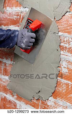Rendering a brick wall using trowel, new homes under construction, construction site View Large Photo Image Stock Image - Rendering a brick wall using trowel, new homes under construction, construction site. Fotosearch