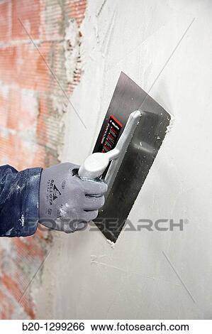 Rendering a brick wall using trowel, new homes under construction, construction site View Large Photo Image Stock Photograph - Rendering a brick wall using trowel, new homes under construction, construction site. Fotosearch
