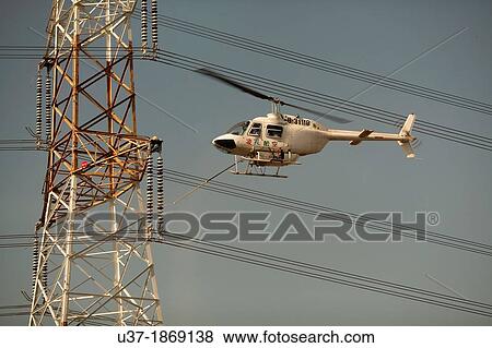 Repairing the High voltage towers with helicopter along the Taiwan highway. View Large Photo Image Stock Photo - Repairing the High voltage towers with helicopter along the Taiwan highway.. Fotosearch