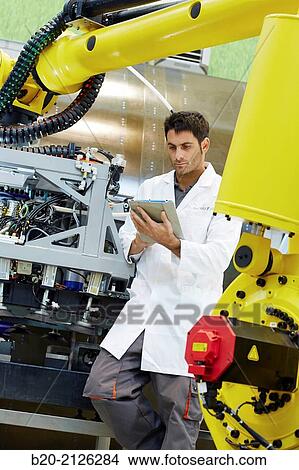 Picture - Research and development for the design of robotic manufacturing cell to work in aircraft component. Industry and Transport. Research & innovation.. Fotosearch