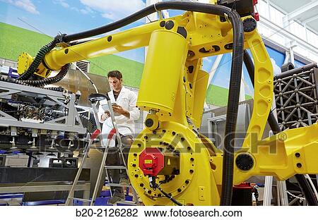 Stock Image - Research and development for the design of robotic manufacturing cell to work in aircraft component. Industry and Transport. Research & innovation.. Fotosearch