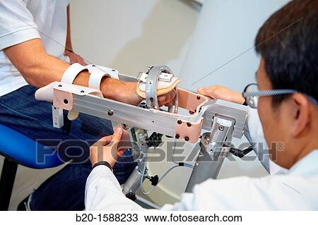 Researcher placing a patient clinical training device of the limb has multiple modes of training wrist and arm View Large Photo Image Stock Image - Researcher placing a patient clinical training device of the limb has multiple modes of training wrist and arm. Fotosearch