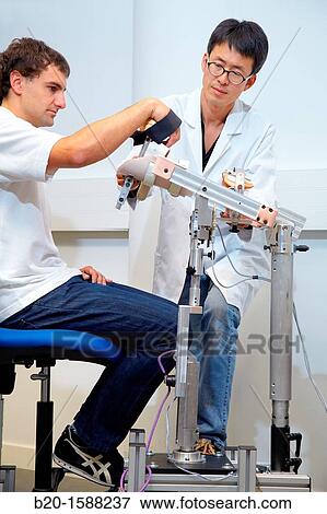 Stock Photo - Researcher placing a patient clinical training device of the limb has multiple modes of training wrist and arm. Fotosearch