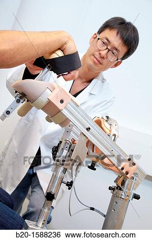 Researcher placing a patient clinical training device of the limb has multiple modes of training wrist and arm View Large Photo Image Stock Photograph - Researcher placing a patient clinical training device of the limb has multiple modes of training wrist and arm. Fotosearch