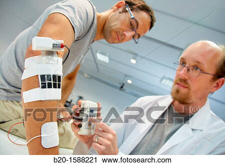 Researcher placing multipad electrodes in the control arm for the stimulation model for sensor signals View Large Photo Image Stock Image - Researcher placing multipad electrodes in the control arm for the stimulation model for sensor signals. Fotosearch
