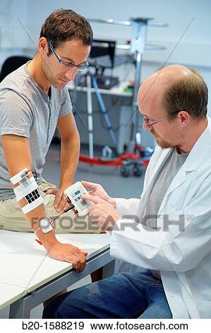 Researcher placing multipad electrodes in the control arm for the stimulation model for sensor signals View Large Photo Image Stock Photo - Researcher placing multipad electrodes in the control arm for the stimulation model for sensor signals. Fotosearch