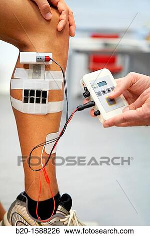 Researcher placing multipad electrodes in the leg to control stimulation models of sensor signals View Large Photo Image Stock Photograph - Researcher placing multipad electrodes in the leg to control stimulation models of sensor signals. Fotosearch