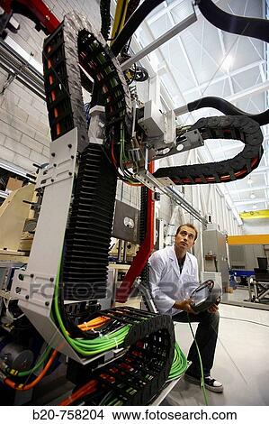 Researcher working on Roptalmu portable robot to drill holes into aircraft components, Fatronik-Tecnalia, Research and Technology Center, Donostia, Basque Country, Spain View Large Photo Image Picture - Researcher working on Roptalmu portable robot to drill holes into aircraft components, Fatronik-Tecnalia, Research and Technology Center, Donostia, Basque Country, Spain. Fotosearch