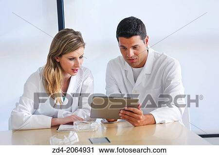 Researchers with a tablet talking in meeting room. Donostia. San Sebastian. Gipuzkoa. Basque country. Spain. View Large Photo Image Stock Image - Researchers with a tablet talking in meeting room. Donostia. San Sebastian. Gipuzkoa. Basque country. Spain.. Fotosearch