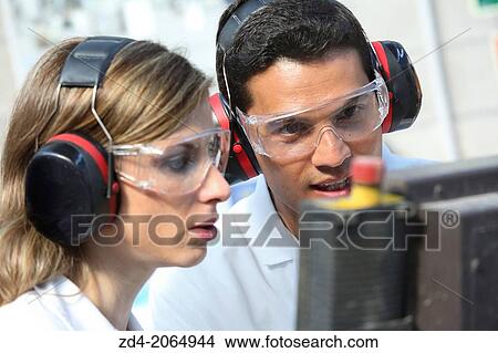 Researchers with glasses and ear protection. View Large Photo Image Picture - Researchers with glasses and ear protection.. Fotosearch