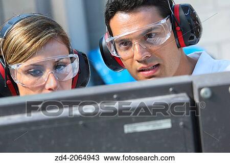 Stock Image - Researchers with glasses and ear protection.. Fotosearch