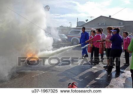Residents trying their hands on Fire extinguisher, Sg. Maong Community Hall, Kuching, Sarawak, Malaysia.. View Large Photo Image Stock Photography - Residents trying their hands on Fire extinguisher, Sg. Maong Community Hall, Kuching, Sarawak, Malaysia... Fotosearch