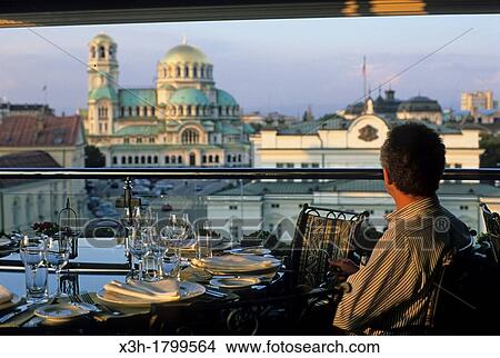 Picture - restaurant of the Radisson hotel opposite the National Assembly with with Alexander Nevsky Cathedral background, Sofia, Bulgaria, Europe. Fotosearch