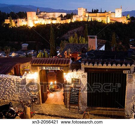 Stock Image - Restaurant, on background The Alhambra Palace from Mirador of San Nicolas in the Albayzin or Albaic? n quarter, Granada, Andalusia, Spain, Europe.. Fotosearch