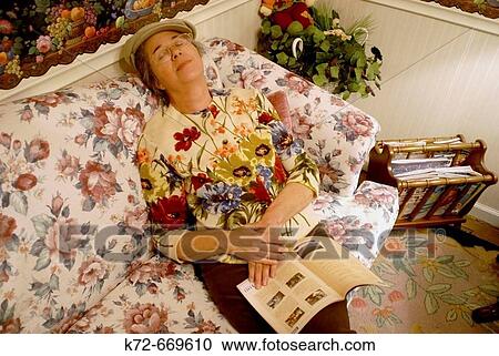 Resting amidst flowery sofa and sweater. View Large Photo Image Stock Image - Resting amidst flowery sofa and sweater.. Fotosearch