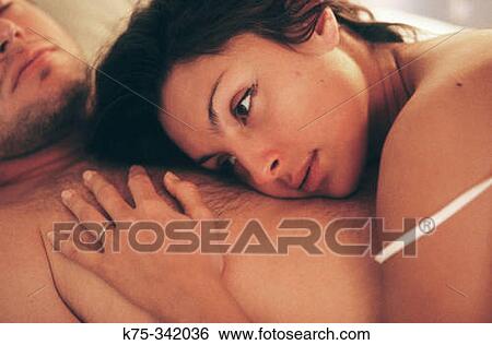 Stock Photograph - Resting her head on his chest. Fotosearch