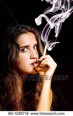 Restless girl smoking View Large Photo Image Stock Photo - Restless girl smoking. Fotosearch