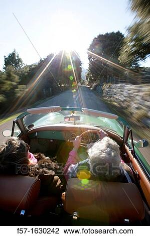 Stock Image - Retired couple driving their Classic 1959 Porsche 356A Cabriolet. Fotosearch
