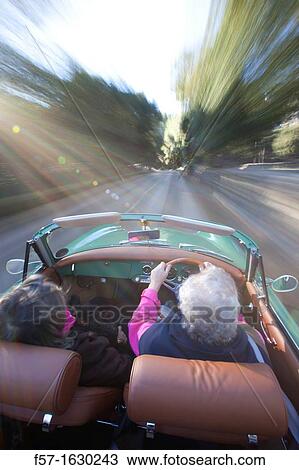 Stock Image - Retired couple driving their Classic 1959 Porsche 356A Cabriolet. Fotosearch