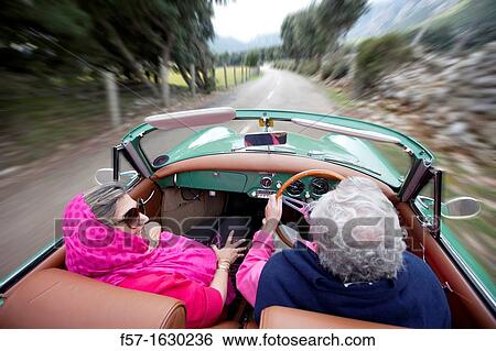 Stock Photograph - Retired couple driving their Classic 1959 Porsche 356A Cabriolet. Fotosearch