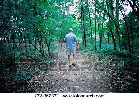 Retired man walking in path in Ohio park. USA. View Large Photo Image Stock Image - Retired man walking in path in Ohio park. USA.. Fotosearch