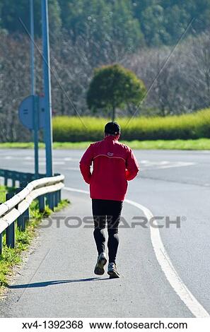 Retired people running on the road Bermeo, Biscay, Basque Country, Spain View Large Photo Image Stock Photo - Retired people running on the road Bermeo, Biscay, Basque Country, Spain. Fotosearch