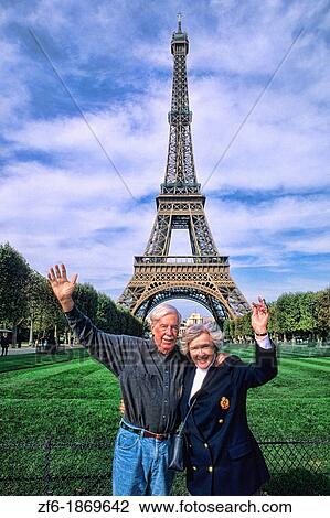 Retired senior couple celebrating in front of Eiffel Tower in Paris France View Large Photo Image Stock Image - Retired senior couple celebrating in front of Eiffel Tower in Paris France. Fotosearch