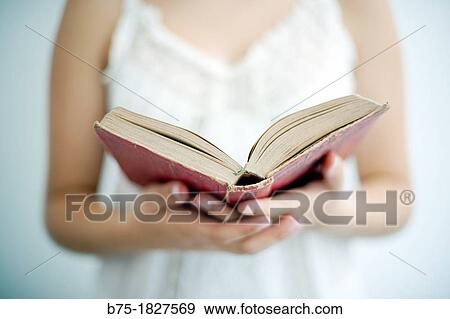 Stock Photo - retrato de joven leyendo un libro, portrait of young girl reading a book,. Fotosearch