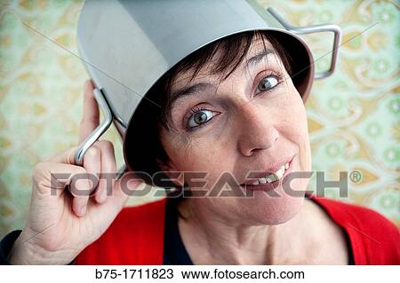 Retrato de mujer de pelo moreno y ojos verdes con una olla en la cabeza, Portrait of brown-haired woman with green eyes and a pot on his head, View Large Photo Image Stock Image - Retrato de mujer de pelo moreno y ojos verdes con una olla en la cabeza, Portrait of brown-haired woman with green eyes and a pot on his head,. Fotosearch