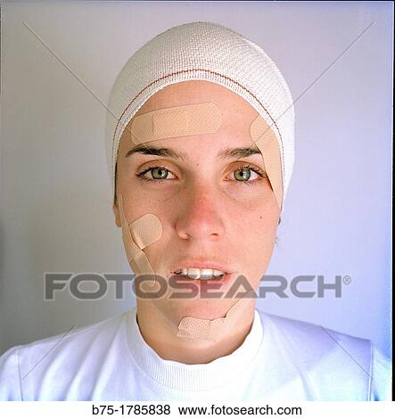 Stock Photo - retrato de mujer joven herida en la cara con vendajes en la cabeza, portrait of young woman hit in the face with head bandages,. Fotosearch