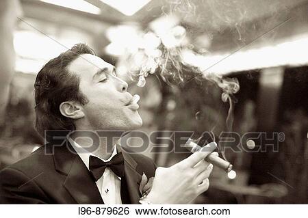 retro, vintage groom enjoying a cigar at his reception View Large Photo Image Stock Photograph - retro, vintage groom enjoying a cigar at his reception. Fotosearch