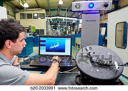Stock Image - Rexcan CS +. White Light System. Technician inspecting production piece in 3D measurement system without contact. Innovative Metrology applied. Sariki Metrology. Elgoibar. Gipuzkoa. Basque Country. Spain.. Fotosearch