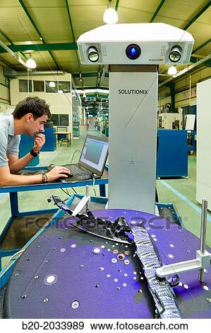 Stock Photo - Rexcan CS +. White Light System. Technician inspecting production piece in 3D measurement system without contact. Innovative Metrology applied. Sariki Metrology. Elgoibar. Gipuzkoa. Basque Country. Spain.. Fotosearch