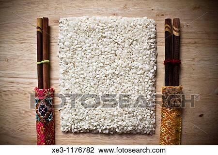 Rice with chopsticks for two View Large Photo Image Stock Image - Rice with chopsticks for two. Fotosearch