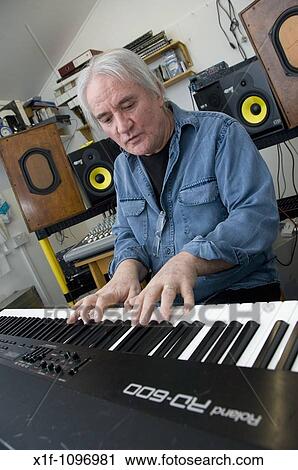 Rick Lloyd, former member of the British 80's band the Flying Pickets playing keyboard in his home studio in Cwm Ystwyth village near Aberystwyth, Wales, UK View Large Photo Image Stock Image - Rick Lloyd, former member of the British 80's band the Flying Pickets playing keyboard in his home studio in Cwm Ystwyth village near Aberystwyth, Wales, UK. Fotosearch