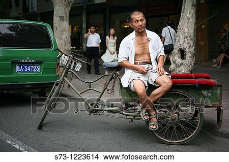 Rickshaw driver sitting of his vehicle, Xian, China, Asia View Large Photo Image Picture - Rickshaw driver sitting of his vehicle, Xian, China, Asia. Fotosearch