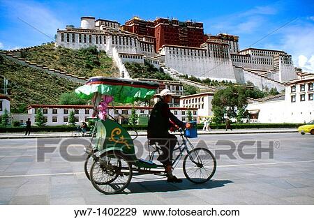 Stock Photo - Rickshaw passing by Potala Palace in Lhasa, Tibet The Potala Palace is located in Lhasa, Tibet Autonomous Region of the People's Republic of China. Fotosearch